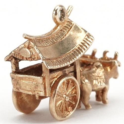 2016 - 9ct gold charm in the form of two oxen pulling an Indonesian cart, 2.1cm in length, 4.9g