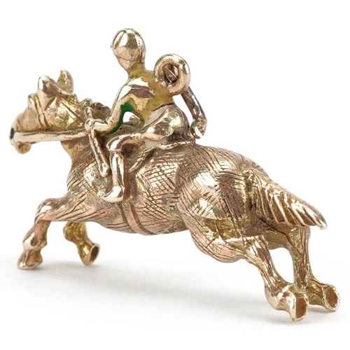 2070 - 9ct gold and enamel charm in the form of a jockey on horseback, 2.9cm wide, 5.0g