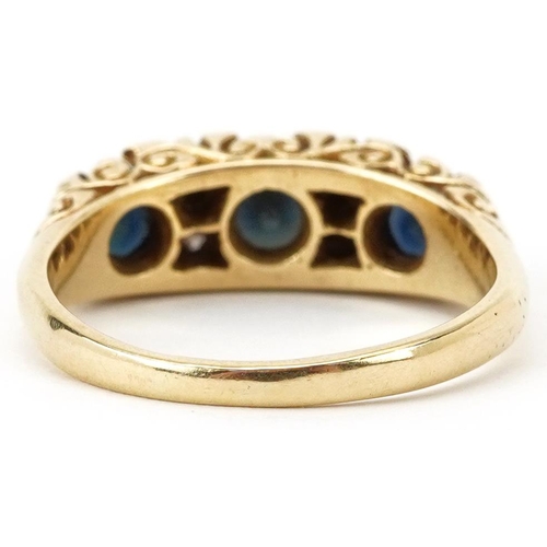 2203 - 18ct gold graduated sapphire and diamond seven stone ring with scrolled setting, size O, 5.8g