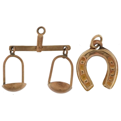 2599 - Two 9ct gold charms comprising balance scales and lucky horseshoe, the largest 2.3cm wide, total 1.1... 