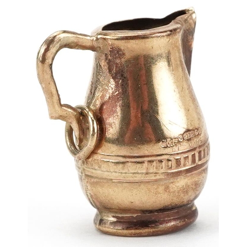 2186 - 9ct gold charm in the form of a water jug, 2cm high, 1.8g