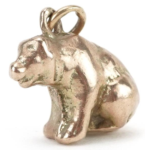 2222 - Unmarked gold charm in the form of a seated bear, tests as 9ct gold, 1.3cm high, 4.3g