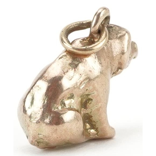 2222 - Unmarked gold charm in the form of a seated bear, tests as 9ct gold, 1.3cm high, 4.3g