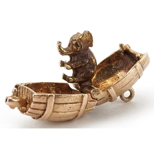 2060 - 9ct gold charm in the form of a beer barrel opening to reveal two hinged elephants, 1.9cm wide, 6.8g