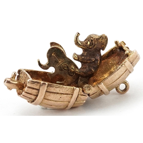 2060 - 9ct gold charm in the form of a beer barrel opening to reveal two hinged elephants, 1.9cm wide, 6.8g