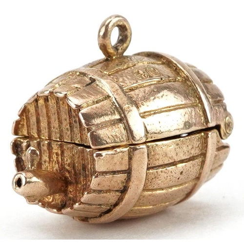 2060 - 9ct gold charm in the form of a beer barrel opening to reveal two hinged elephants, 1.9cm wide, 6.8g