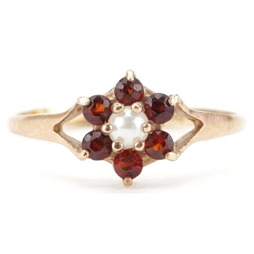 2582 - 9ct gold garnet and seed pearl flower head ring with split shoulders, size L, 1.1g