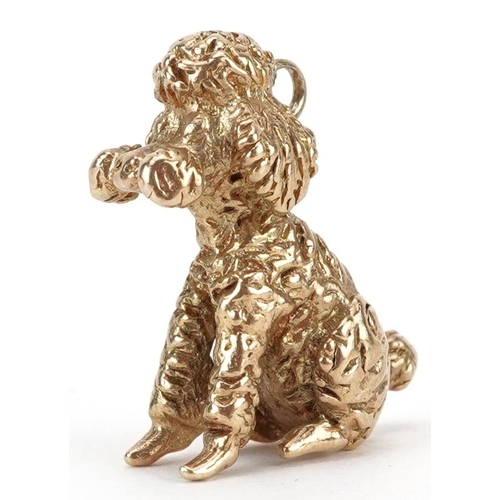 2042 - 9ct gold charm in the form of a seated poodle, 2cm high, 6.8g