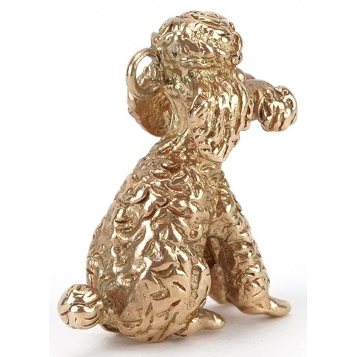 2042 - 9ct gold charm in the form of a seated poodle, 2cm high, 6.8g