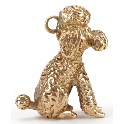 2042 - 9ct gold charm in the form of a seated poodle, 2cm high, 6.8g