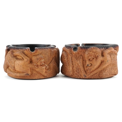 520 - Matched pair of smoking interest Meerschaum ashtrays decorated in relief with figures, each 10cm in ... 