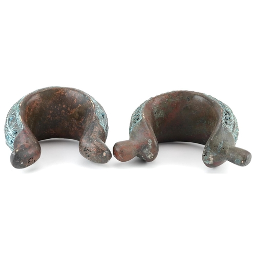 70 - Two West African tribal interest verdigris copper open cuffs, the largest 17.5cm high