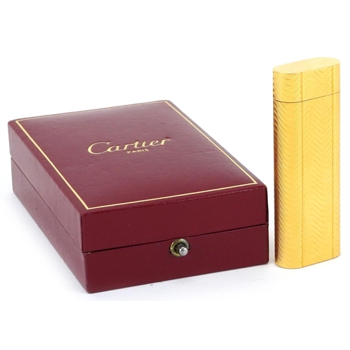 36 - Cartier, gold plated French engine turned pocket lighter with box numbered D24339, 7cm high