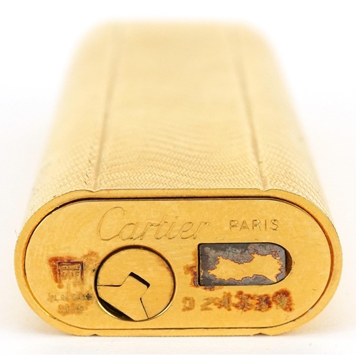 36 - Cartier, gold plated French engine turned pocket lighter with box numbered D24339, 7cm high