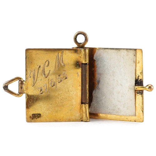 2595 - Two 9ct gold charms in the form of a book and railway lantern with swing handle, the largest 1.9cm h... 