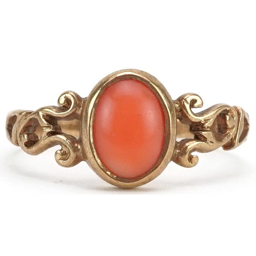 2436 - 9ct gold cabochon pink coral ring with openwork scrolled shoulders, size M, 1.8g