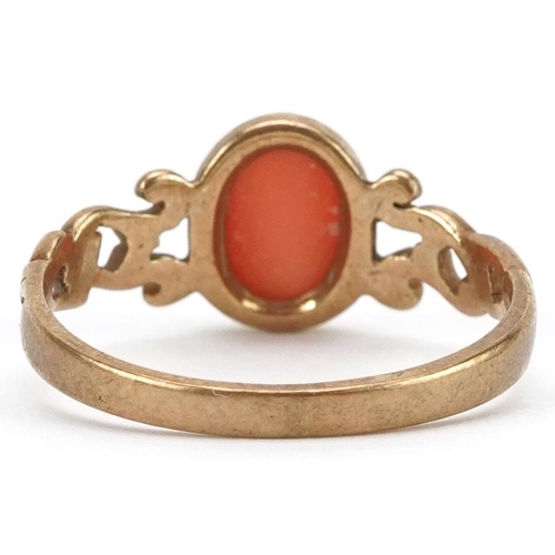 2436 - 9ct gold cabochon pink coral ring with openwork scrolled shoulders, size M, 1.8g