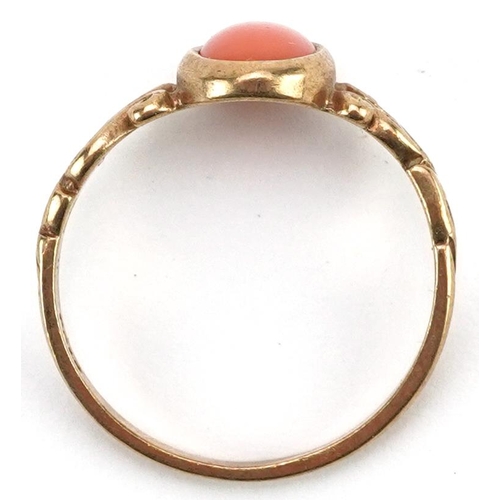 2436 - 9ct gold cabochon pink coral ring with openwork scrolled shoulders, size M, 1.8g