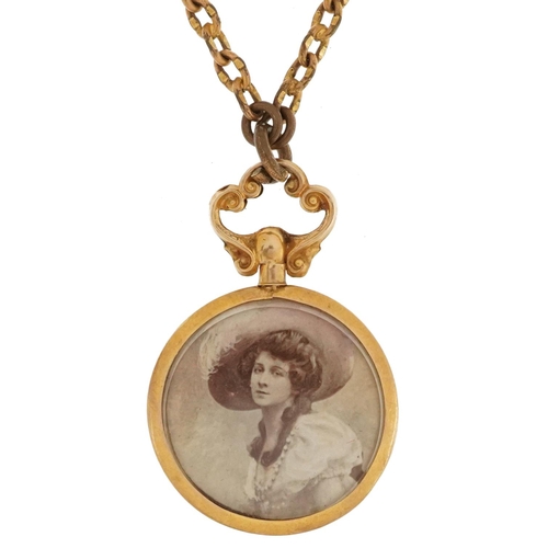 2244 - 9ct gold circular open locket on a yellow metal Longuard chain, 3.5cm high and 130cm in length, tota... 