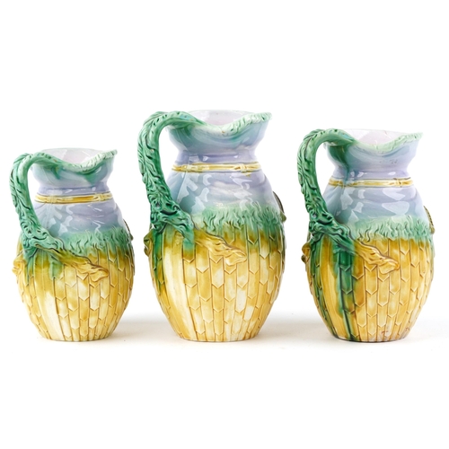  Graduated set of three Majolica jugs, each decorated in relief with a ram's head, the largest 22.5cm... 
