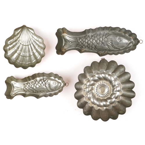 1515 - Four vintage coppered jelly moulds including two in the form of fish, the largest 42cm in length