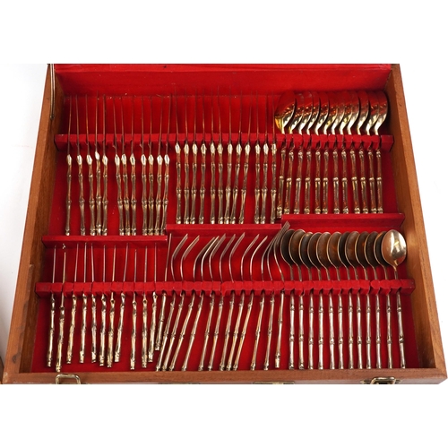 1133 - Thai twelve place canteen of brass cutlery with simulated bamboo handles housed in a hardwood cantee... 