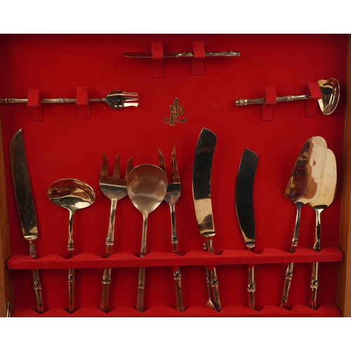 1133 - Thai twelve place canteen of brass cutlery with simulated bamboo handles housed in a hardwood cantee... 