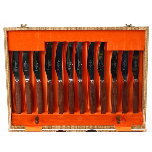 1136 - 1970s Bravingtons six place canteen of stainless steel cutlery with teak handles, the canteen 36.5cm... 