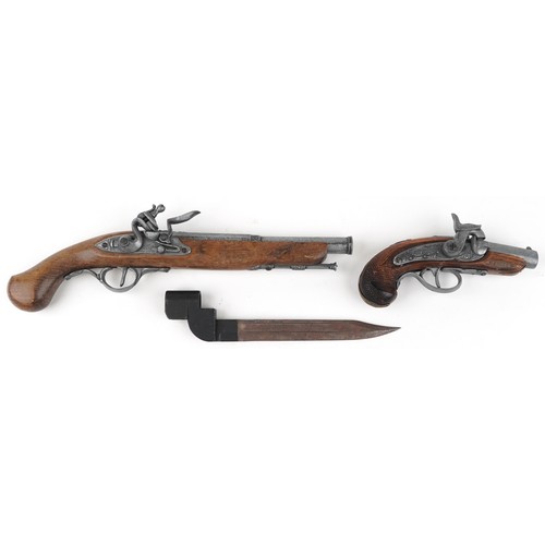 686 - Two decorative model pistols and a bayonet, 38cm in length