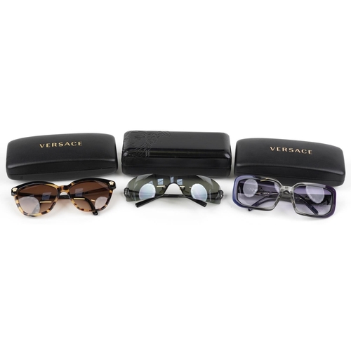 1292 - Three pairs of ladies sunglasses with cases housed in Versace cases comprising two Versace and Chane... 