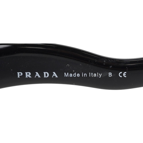 1291 - Three pairs of ladies sunglasses with cases comprising two Gucci and Prada