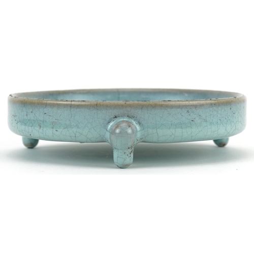 1323 - Chinese porcelain tripod censer having a blue crackle glaze, 14cm in diameter excluding the feet