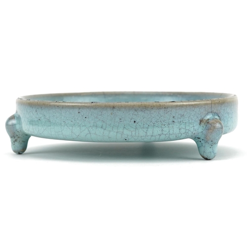 1323 - Chinese porcelain tripod censer having a blue crackle glaze, 14cm in diameter excluding the feet