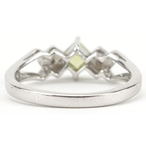 2563 - 9ct white gold peridot and diamond three stone ring with split shoulders, size N, 3.0g