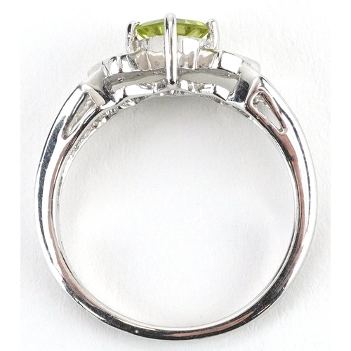 2563 - 9ct white gold peridot and diamond three stone ring with split shoulders, size N, 3.0g