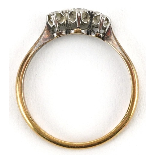 2067 - 18ct gold and platinum diamond three stone ring, the central diamond approximately 0.12 carat, size ... 