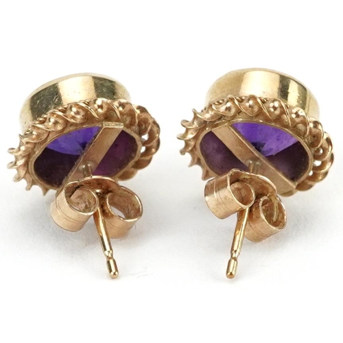 2074 - Pair of 9ct gold amethyst solitaire stud earrings, 11mm in diameter, 2.4g