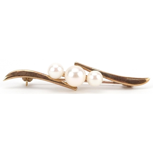 2442 - Mikimoto, Japanese 9ct gold graduated Mikimoto pearl crossover bar brooch, 4.4cm wide, 2.5g