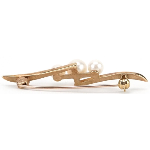 2442 - Mikimoto, Japanese 9ct gold graduated Mikimoto pearl crossover bar brooch, 4.4cm wide, 2.5g