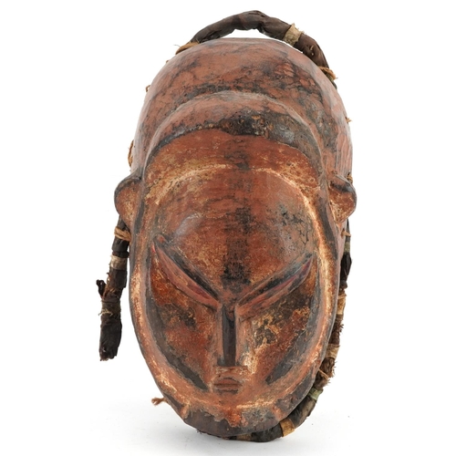 410 - African tribal interest lacquered carved hardwood face mask, 28cm high