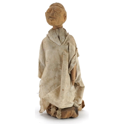 413 - Tribal interest carved wood Voodoo doll wearing a white cape, possibly from South Sea Islands, 35.5c... 