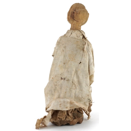 413 - Tribal interest carved wood Voodoo doll wearing a white cape, possibly from South Sea Islands, 35.5c... 