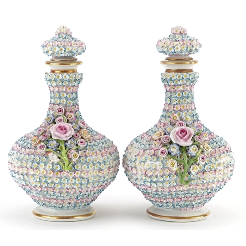 74 - Pair of 19th century continental floral encrusted porcelain scent bottles with stoppers, each 20cm h... 