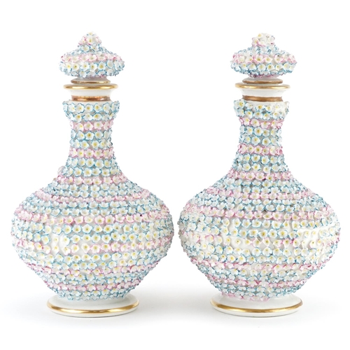 74 - Pair of 19th century continental floral encrusted porcelain scent bottles with stoppers, each 20cm h... 