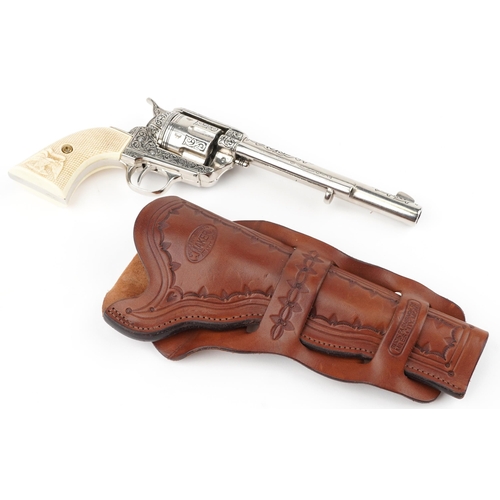 693 - Decorative model of a Colt single action army revolver with ivorine grip and leather holster, 32cm i... 