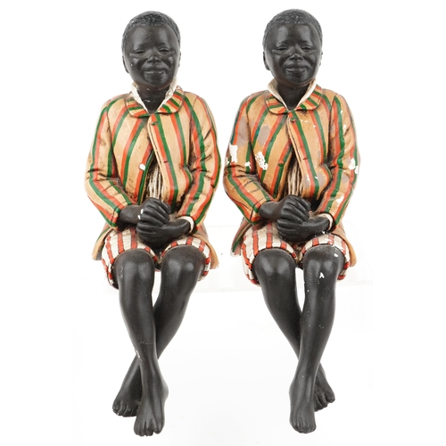 1300 - Pair of hand painted plaster bookends in the form of Blackamoors, each 46cm high