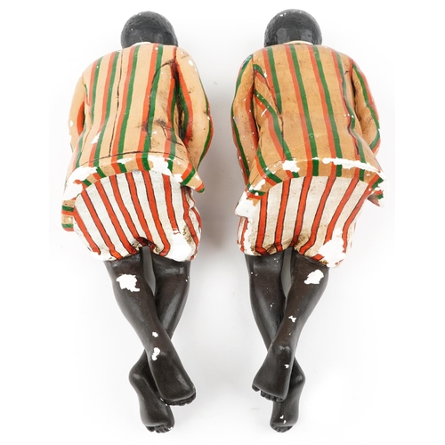 1300 - Pair of hand painted plaster bookends in the form of Blackamoors, each 46cm high