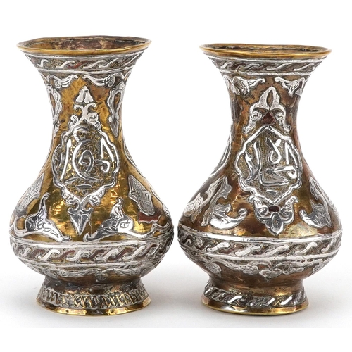 270 - Pair of Islamic brass vases with silver foliate inlay, each 10cm high