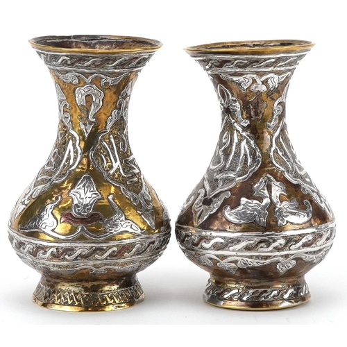 270 - Pair of Islamic brass vases with silver foliate inlay, each 10cm high