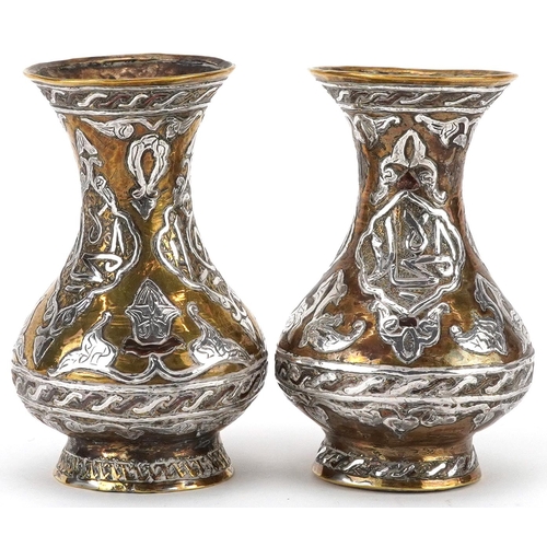 270 - Pair of Islamic brass vases with silver foliate inlay, each 10cm high